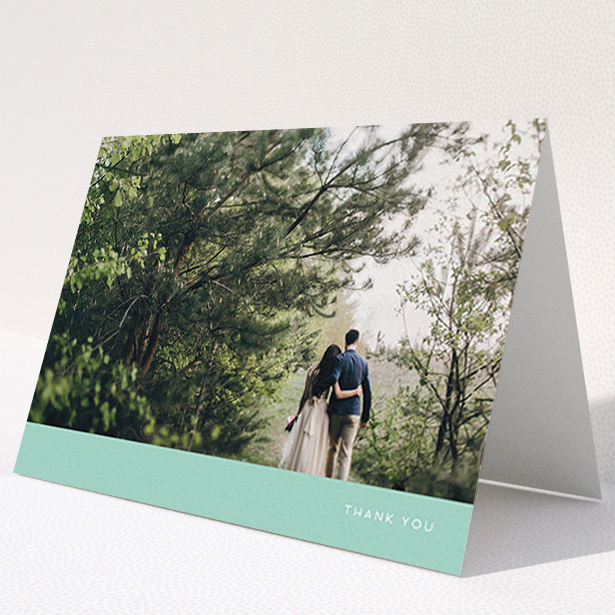 A photo wedding thank you card template titled "Simple Mint". It is an A6 card in a landscape orientation. It is a photographic photo wedding thank you card with room for 1 photo. "Simple Mint" is available as a folded card, with tones of green and white.