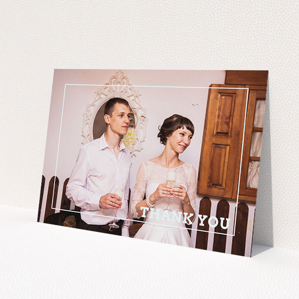 A photo wedding thank you card design titled 'Simple Thank You Frame'. It is an A5 card in a landscape orientation. It is a photographic photo wedding thank you card with room for 1 photo. 'Simple Thank You Frame' is available as a flat card, with mainly white colouring.