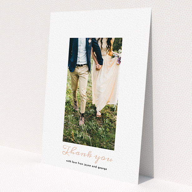 A photo wedding thank you card called 'Small and Central'. It is an A6 card in a portrait orientation. It is a photographic photo wedding thank you card with room for 1 photo. 'Small and Central' is available as a flat card, with tones of white and pink.