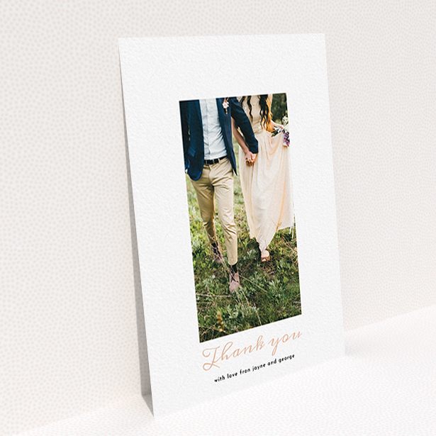 A photo wedding thank you card called "Small and Central". It is an A6 card in a portrait orientation. It is a photographic photo wedding thank you card with room for 1 photo. "Small and Central" is available as a flat card, with tones of white and pink.