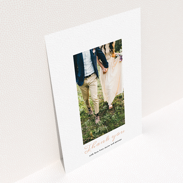 A photo wedding thank you card called "Small and Central". It is an A6 card in a portrait orientation. It is a photographic photo wedding thank you card with room for 1 photo. "Small and Central" is available as a flat card, with tones of white and pink.