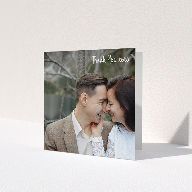 A photo wedding thank you card design named 'Thank You XOXO'. It is a square (148mm x 148mm) card in a square orientation. It is a photographic photo wedding thank you card with room for 1 photo. 'Thank You XOXO' is available as a folded card, with mainly white colouring.