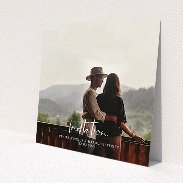 A wedding invite card named 'Central Script'. It is a square (148mm x 148mm) invite in a square orientation. It is a photographic wedding invite card with room for 1 photo. 'Central Script' is available as a flat invite, with mainly white colouring.