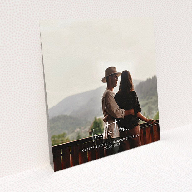 A wedding invite card named "Central Script". It is a square (148mm x 148mm) invite in a square orientation. It is a photographic wedding invite card with room for 1 photo. "Central Script" is available as a flat invite, with mainly white colouring.