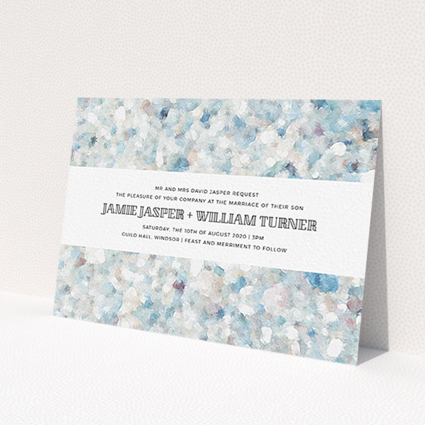 A wedding invite card design titled 'Speckled Oils'. It is an A6 invite in a landscape orientation. 'Speckled Oils' is available as a flat invite, with tones of light blue, light grey and white.