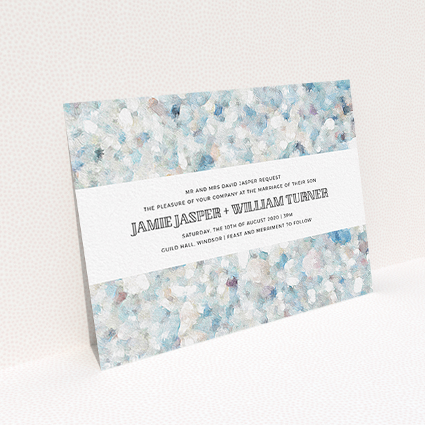 A wedding invite card design titled "Speckled Oils". It is an A6 invite in a landscape orientation. "Speckled Oils" is available as a flat invite, with tones of light blue, light grey and white.
