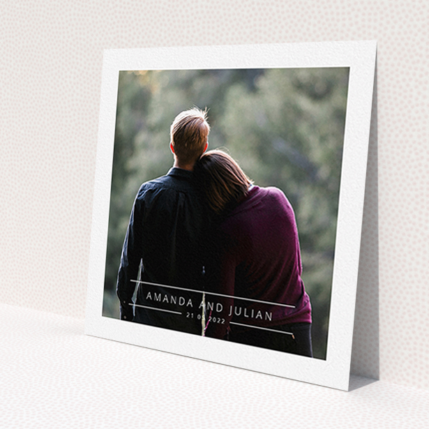 A wedding invite card named 'Tramlines'. It is a square (148mm x 148mm) invite in a square orientation. It is a photographic wedding invite card with room for 1 photo. 'Tramlines' is available as a flat invite, with mainly white colouring.