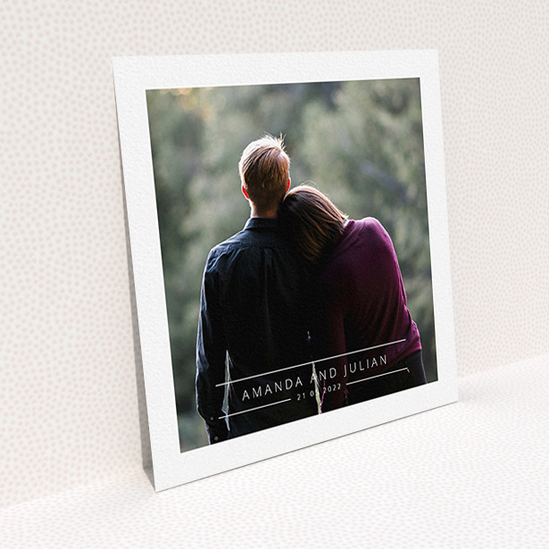 A wedding invite card named "Tramlines". It is a square (148mm x 148mm) invite in a square orientation. It is a photographic wedding invite card with room for 1 photo. "Tramlines" is available as a flat invite, with mainly white colouring.