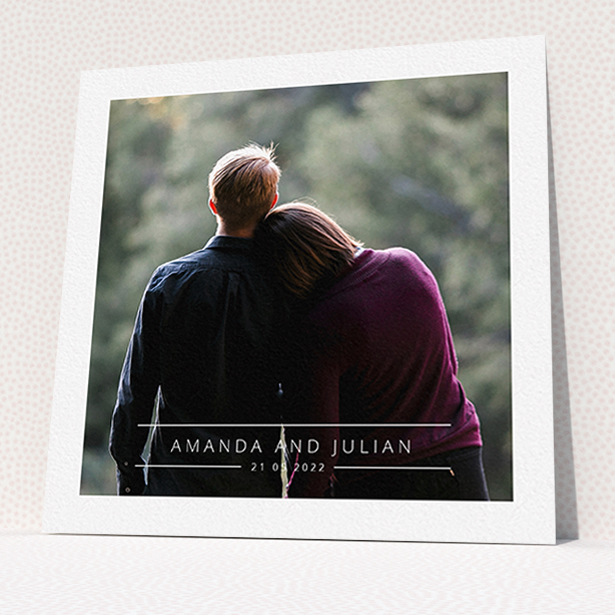 A wedding invite card named "Tramlines". It is a square (148mm x 148mm) invite in a square orientation. It is a photographic wedding invite card with room for 1 photo. "Tramlines" is available as a flat invite, with mainly white colouring.