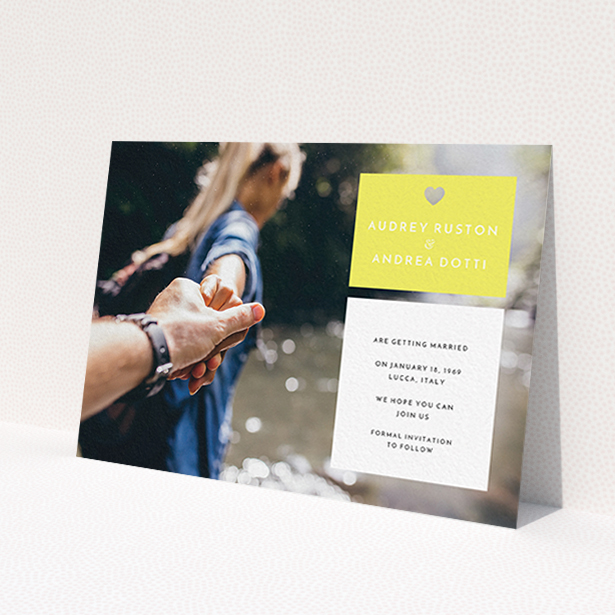 A wedding save the date card template titled 'Boxed In'. It is an A6 card in a landscape orientation. It is a photographic wedding save the date card with room for 1 photo. 'Boxed In' is available as a flat card, with mainly yellow colouring.