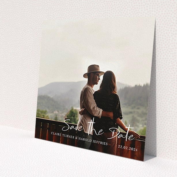 A wedding save the date card design named 'Central Script'. It is a square (148mm x 148mm) card in a square orientation. It is a photographic wedding save the date card with room for 1 photo. 'Central Script' is available as a flat card, with mainly white colouring.