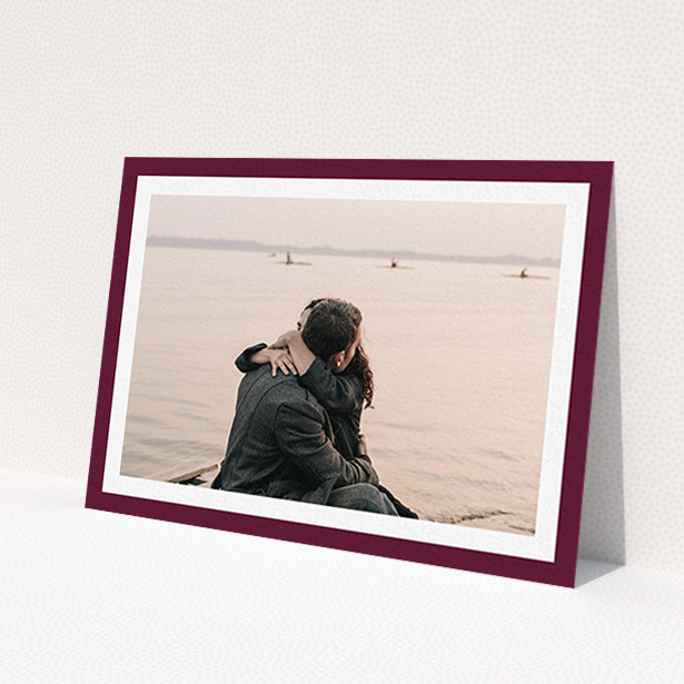 A wedding save the date card design named 'Classic Burgundy Photo Frame'. It is an A6 card in a landscape orientation. It is a photographic wedding save the date card with room for 1 photo. 'Classic Burgundy Photo Frame' is available as a flat card, with tones of burgundy and white.