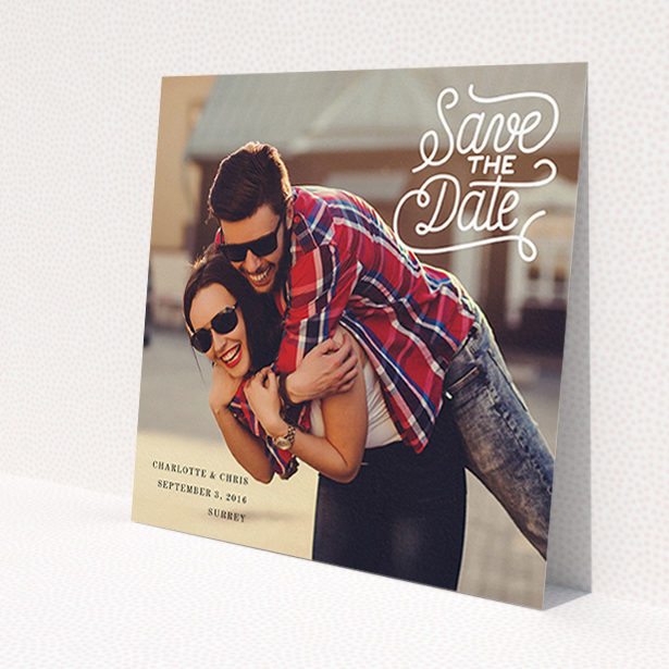A wedding save the date card template titled 'Curly Typography Photo'. It is a square (148mm x 148mm) card in a square orientation. It is a photographic wedding save the date card with room for 1 photo. 'Curly Typography Photo' is available as a flat card, with mainly white colouring.