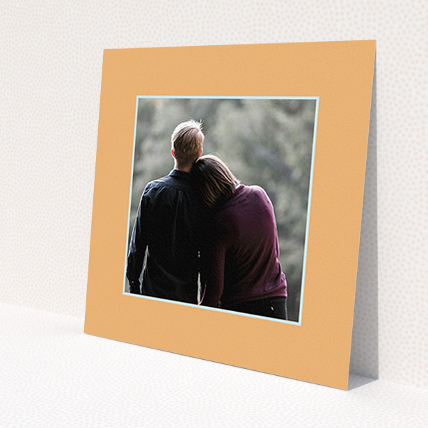 A wedding save the date card named 'Orange Mint Photo Frame'. It is a square (148mm x 148mm) card in a square orientation. It is a photographic wedding save the date card with room for 1 photo. 'Orange Mint Photo Frame' is available as a flat card, with tones of orange and blue.