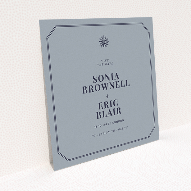 A wedding save the date card called "Shaded sundial". It is a square (148mm x 148mm) card in a square orientation. "Shaded sundial" is available as a flat card, with tones of dark grey and navy blue.