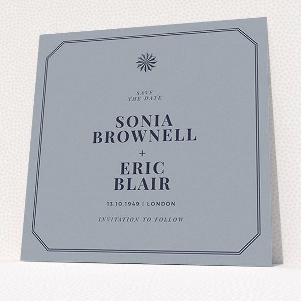 A wedding save the date card called "Shaded sundial". It is a square (148mm x 148mm) card in a square orientation. "Shaded sundial" is available as a flat card, with tones of dark grey and navy blue.