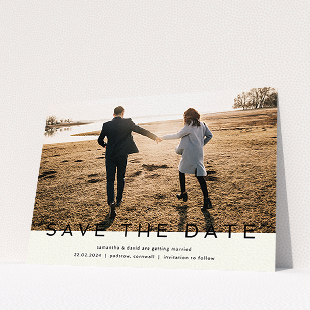 A wedding save the date card called "Simple Saving". It is an A6 card in a landscape orientation. It is a photographic wedding save the date card with room for 1 photo. "Simple Saving" is available as a flat card, with tones of cream and black.