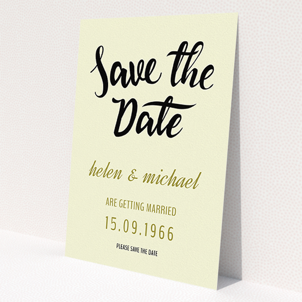 A wedding save the date card called 'Simply Black Typography Pen'. It is an A5 card in a portrait orientation. 'Simply Black Typography Pen' is available as a flat card, with tones of cream, gold and black.