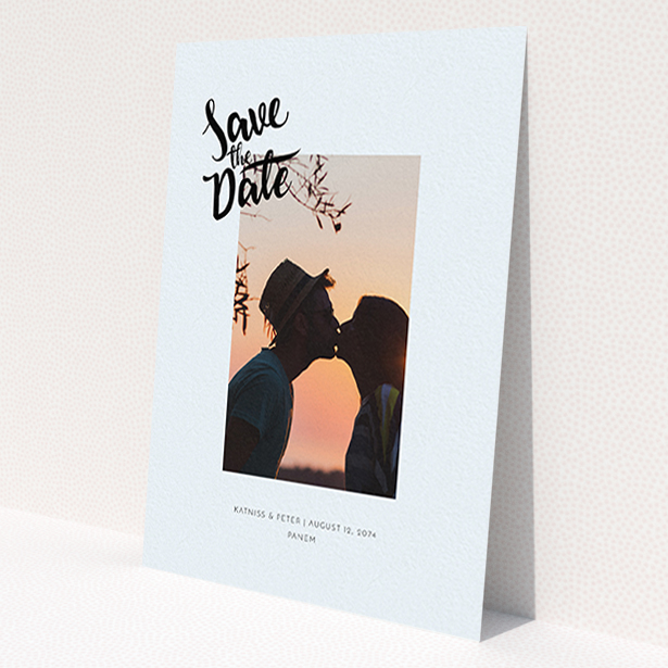 A wedding save the date card design named 'Stamp Typography'. It is an A6 card in a portrait orientation. It is a photographic wedding save the date card with room for 1 photo. 'Stamp Typography' is available as a flat card, with mainly light blue colouring.