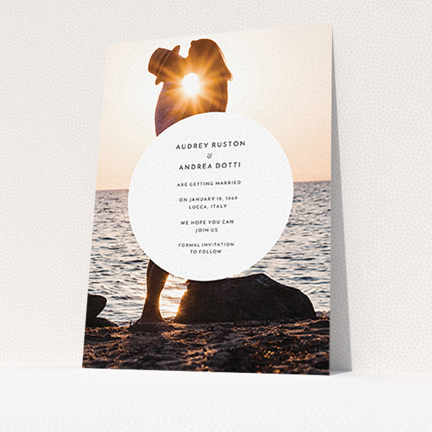 A wedding save the date card template titled "Surrounded". It is an A6 card in a portrait orientation. It is a photographic wedding save the date card with room for 1 photo. "Surrounded" is available as a flat card, with mainly white colouring.