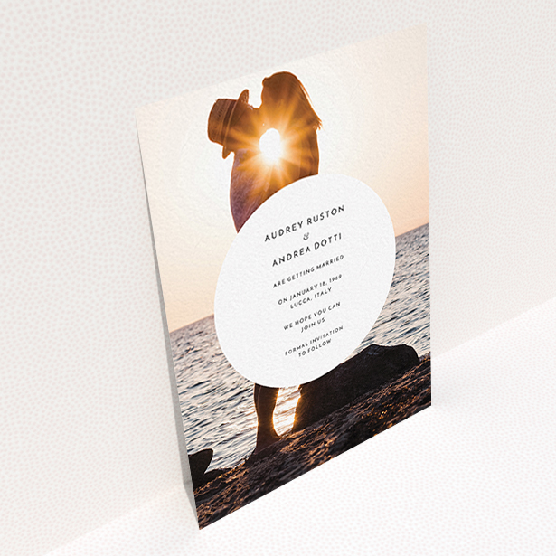 A wedding save the date card template titled "Surrounded". It is an A6 card in a portrait orientation. It is a photographic wedding save the date card with room for 1 photo. "Surrounded" is available as a flat card, with mainly white colouring.