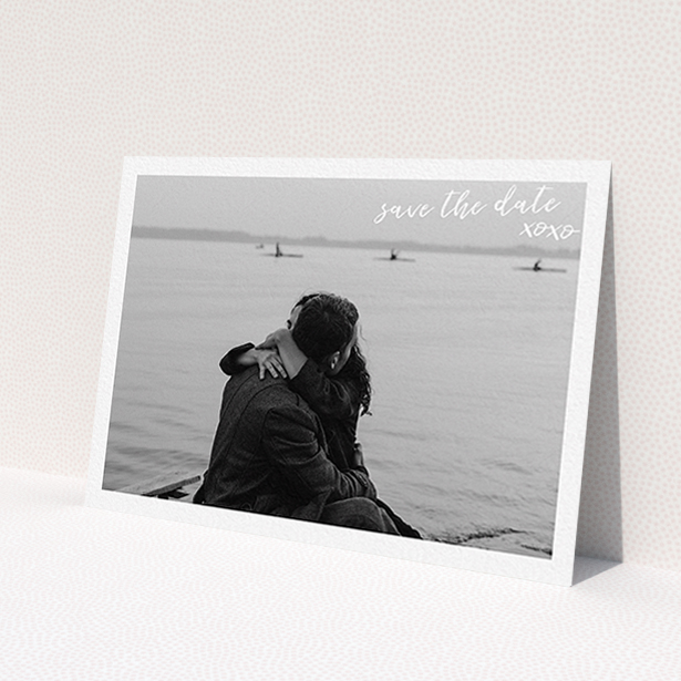 A wedding save the date card design called 'Thick White Framed Photo'. It is an A6 card in a landscape orientation. It is a photographic wedding save the date card with room for 1 photo. 'Thick White Framed Photo' is available as a flat card, with mainly white colouring.
