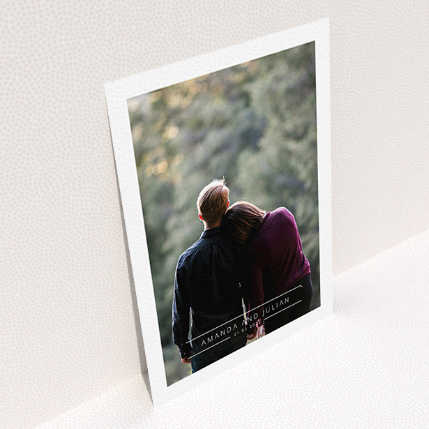 A wedding save the date card design called "Tramlines". It is an A6 card in a portrait orientation. It is a photographic wedding save the date card with room for 1 photo. "Tramlines" is available as a flat card, with mainly white colouring.
