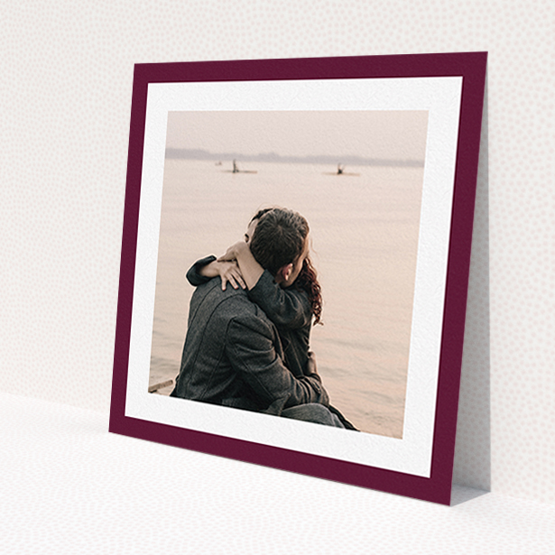 A wedding save the date template titled 'Classic Burgundy Photo Frame'. It is a square (148mm x 148mm) save the date in a square orientation. It is a photographic wedding save the date with room for 1 photo. 'Classic Burgundy Photo Frame' is available as a flat save the date, with tones of burgundy and white.