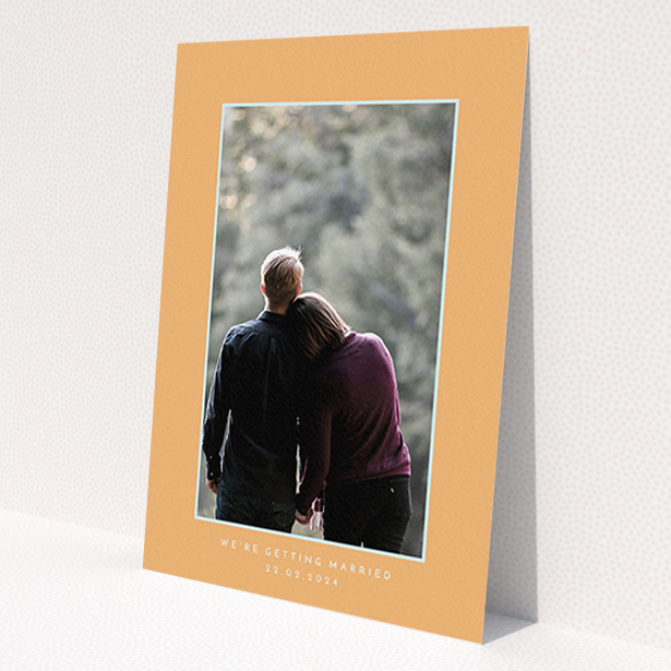 A wedding save the date template titled 'Orange Mint Photo Frame'. It is an A6 save the date in a portrait orientation. It is a photographic wedding save the date with room for 1 photo. 'Orange Mint Photo Frame' is available as a flat save the date, with tones of orange and blue.