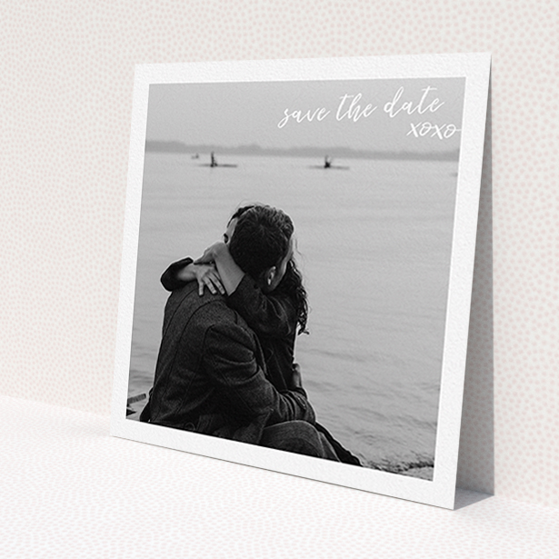 A wedding save the date called 'Thick White Framed Photo'. It is a square (148mm x 148mm) save the date in a square orientation. It is a photographic wedding save the date with room for 1 photo. 'Thick White Framed Photo' is available as a flat save the date, with mainly white colouring.