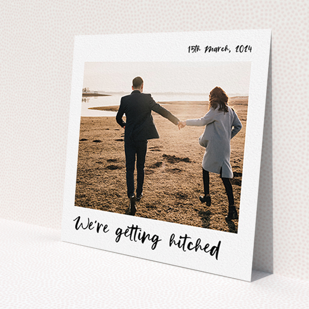 A wedding save the date template titled 'Top and Bottom Photo'. It is a square (148mm x 148mm) save the date in a square orientation. It is a photographic wedding save the date with room for 1 photo. 'Top and Bottom Photo' is available as a flat save the date, with mainly white colouring.