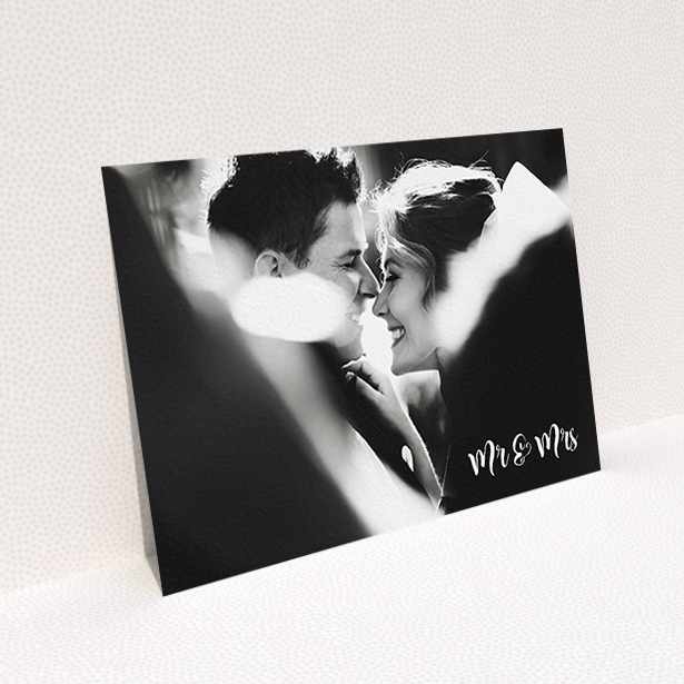A wedding thank you card design called "Black and White". It is an A6 card in a landscape orientation. It is a photographic wedding thank you card with room for 1 photo. "Black and White" is available as a flat card, with mainly white colouring.