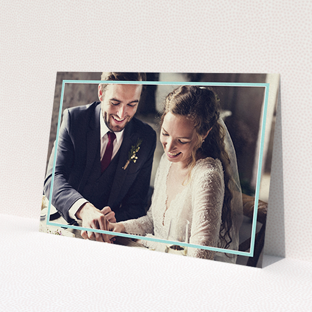 A wedding thank you card design called 'Blue White Photo Frame'. It is an A6 card in a landscape orientation. It is a photographic wedding thank you card with room for 1 photo. 'Blue White Photo Frame' is available as a flat card, with mainly blue colouring.