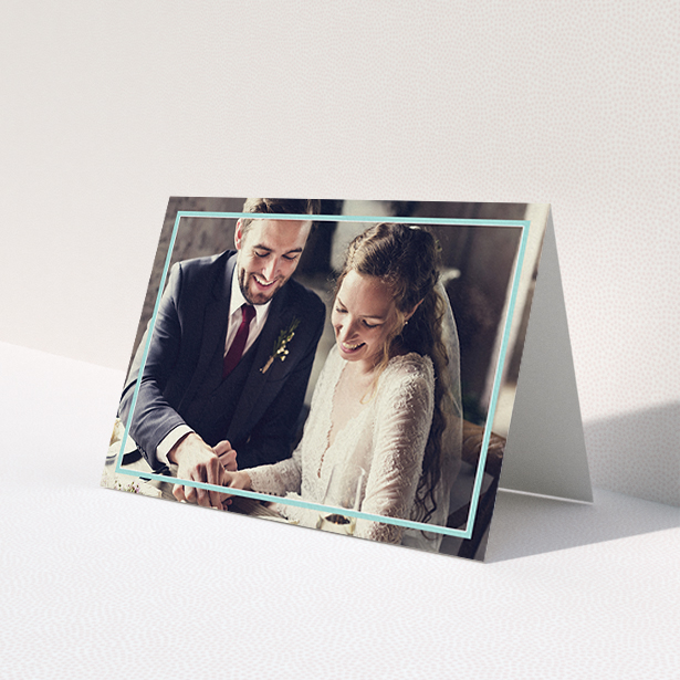 A wedding thank you card template titled 'Blue White Photo Frame'. It is an A6 card in a landscape orientation. It is a photographic wedding thank you card with room for 1 photo. 'Blue White Photo Frame' is available as a folded card, with mainly blue colouring.