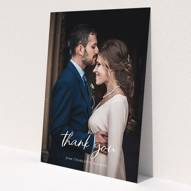 A wedding thank you card design named 'Calligraphy Thanks'. It is an A6 card in a portrait orientation. It is a photographic wedding thank you card with room for 1 photo. 'Calligraphy Thanks' is available as a flat card, with mainly white colouring.
