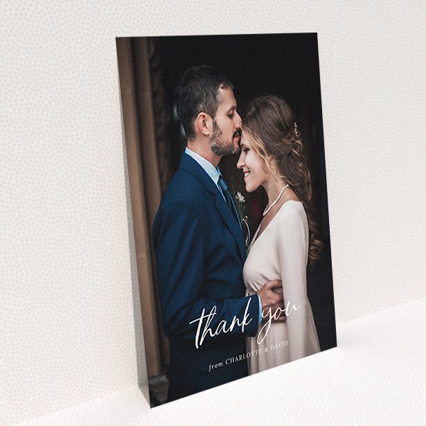 A wedding thank you card design named "Calligraphy Thanks". It is an A6 card in a portrait orientation. It is a photographic wedding thank you card with room for 1 photo. "Calligraphy Thanks" is available as a flat card, with mainly white colouring.