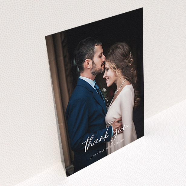 A wedding thank you card design named "Calligraphy Thanks". It is an A6 card in a portrait orientation. It is a photographic wedding thank you card with room for 1 photo. "Calligraphy Thanks" is available as a flat card, with mainly white colouring.