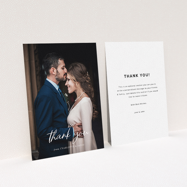 A wedding thank you card design named "Calligraphy Thanks". It is an A6 card in a portrait orientation. It is a photographic wedding thank you card with room for 1 photo. "Calligraphy Thanks" is available as a flat card, with mainly white colouring.