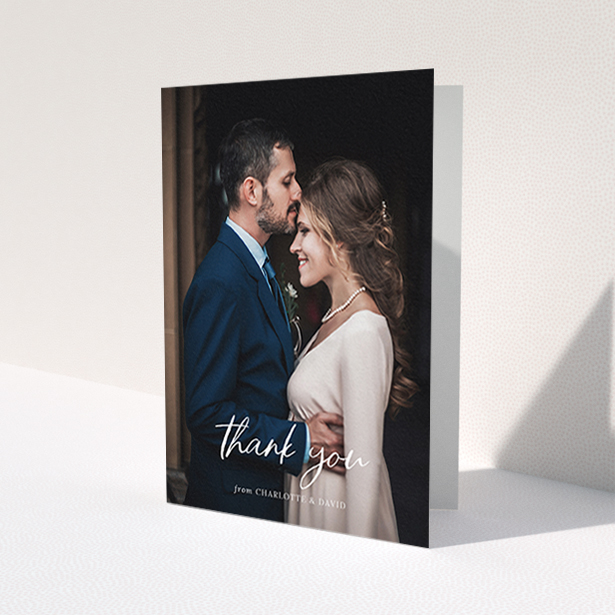 A wedding thank you card design called 'Calligraphy Thanks'. It is an A6 card in a portrait orientation. It is a photographic wedding thank you card with room for 1 photo. 'Calligraphy Thanks' is available as a folded card, with mainly white colouring.