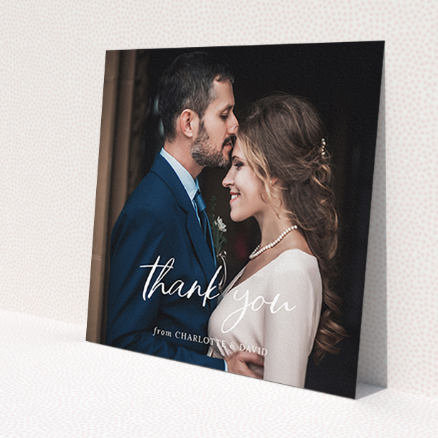 A wedding thank you card design called 'Calligraphy Thanks'. It is a square (148mm x 148mm) card in a square orientation. It is a photographic wedding thank you card with room for 1 photo. 'Calligraphy Thanks' is available as a flat card, with mainly white colouring.