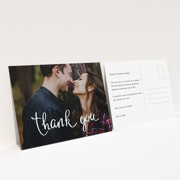 A wedding thank you card design titled "Curly thank you". It is an A6 card in a landscape orientation. It is a photographic wedding thank you card with room for 1 photo. "Curly thank you" is available as a flat card, with mainly white colouring.