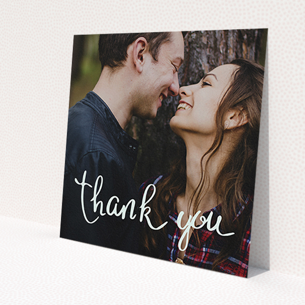 A wedding thank you card design called 'Curly thank you'. It is a square (148mm x 148mm) card in a square orientation. It is a photographic wedding thank you card with room for 1 photo. 'Curly thank you' is available as a flat card, with mainly white colouring.