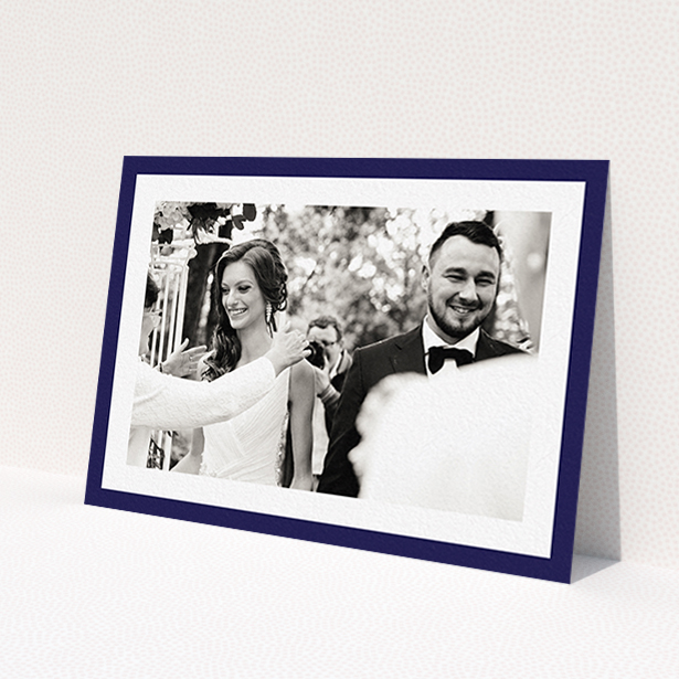 A wedding thank you card design named 'Navy Border'. It is an A6 card in a landscape orientation. It is a photographic wedding thank you card with room for 1 photo. 'Navy Border' is available as a flat card, with tones of blue and white.