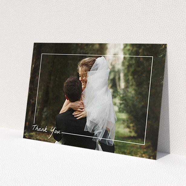 A wedding thank you card design called 'On Photo Border'. It is an A6 card in a landscape orientation. It is a photographic wedding thank you card with room for 1 photo. 'On Photo Border' is available as a flat card, with mainly white colouring.