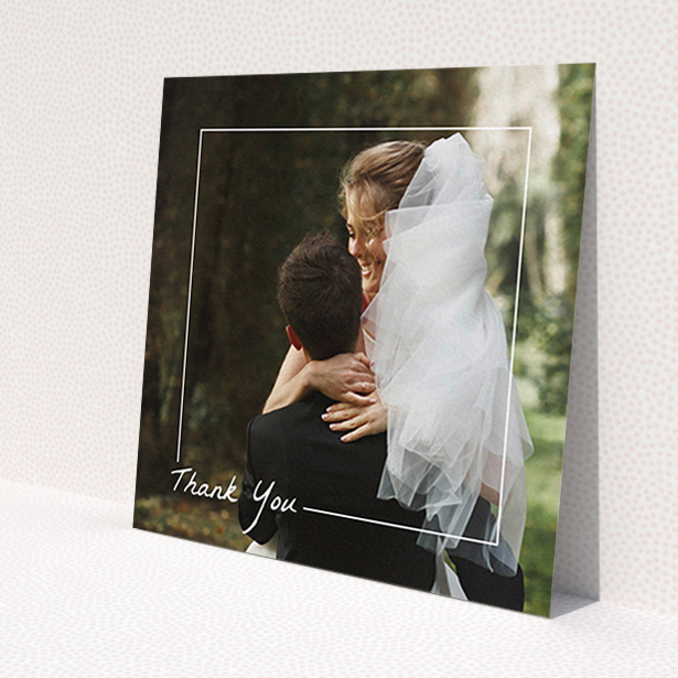 A wedding thank you card named 'On Photo Border'. It is a square (148mm x 148mm) card in a square orientation. It is a photographic wedding thank you card with room for 1 photo. 'On Photo Border' is available as a flat card, with mainly white colouring.