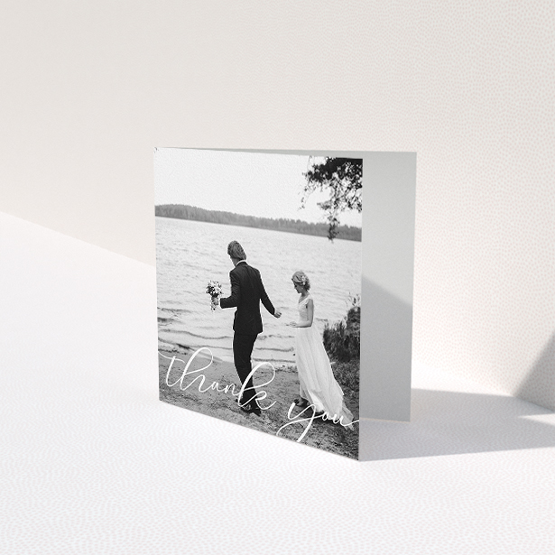 A wedding thank you card design titled "One Photo". It is a square (148mm x 148mm) card in a square orientation. It is a photographic wedding thank you card with room for 1 photo. "One Photo" is available as a folded card, with mainly white colouring.