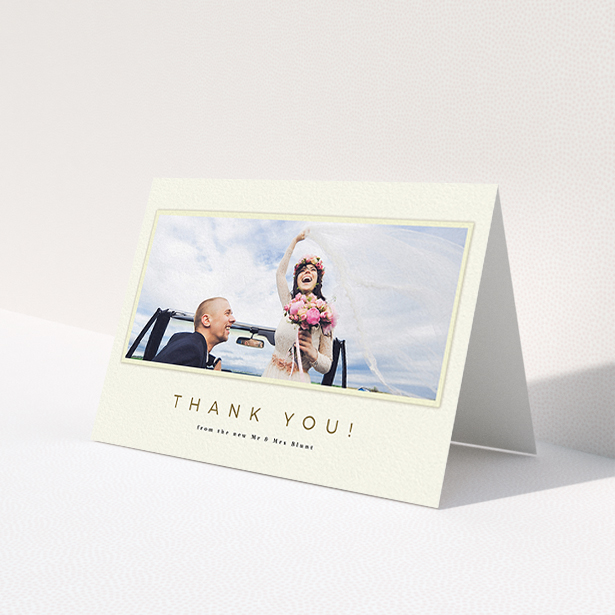 A wedding thank you card template titled 'One white Polaroid '. It is an A6 card in a landscape orientation. It is a photographic wedding thank you card with room for 1 photo. 'One white Polaroid ' is available as a folded card, with mainly cream colouring.