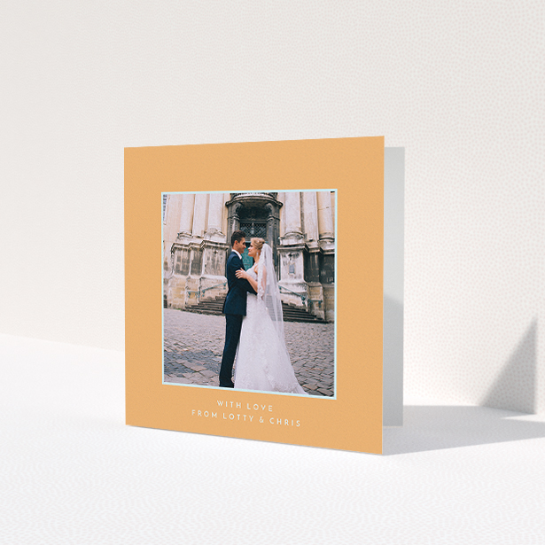 A wedding thank you card named 'Orange and blue'. It is a square (148mm x 148mm) card in a square orientation. It is a photographic wedding thank you card with room for 1 photo. 'Orange and blue' is available as a folded card, with tones of orange and blue.