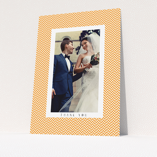 A wedding thank you card design titled "Orange Houndstooth". It is an A5 card in a portrait orientation. It is a photographic wedding thank you card with room for 1 photo. "Orange Houndstooth" is available as a flat card, with tones of orange and white.