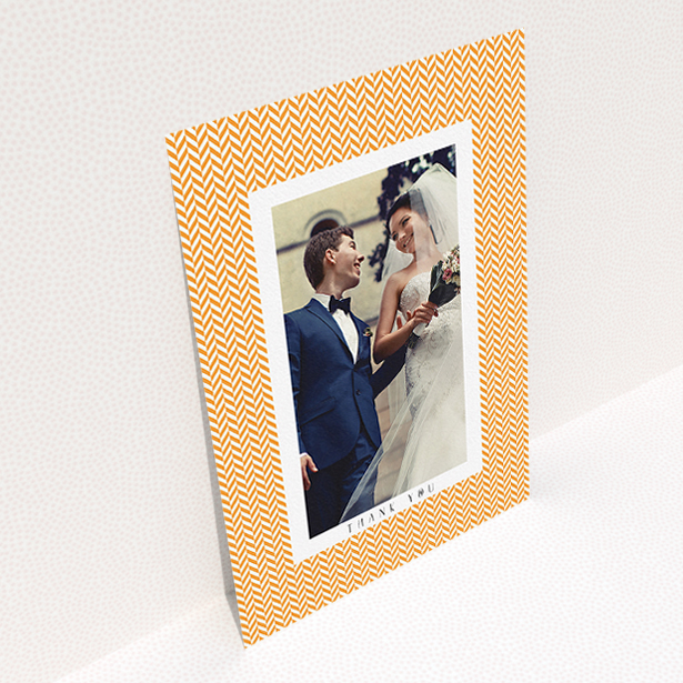 A wedding thank you card design titled "Orange Houndstooth". It is an A5 card in a portrait orientation. It is a photographic wedding thank you card with room for 1 photo. "Orange Houndstooth" is available as a flat card, with tones of orange and white.